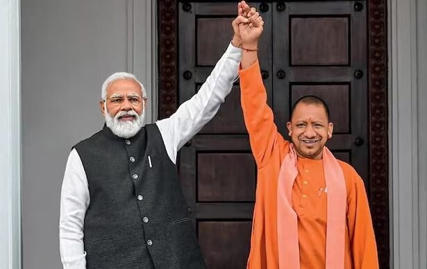 प्रधानमंत्री नरेंद्र मोदी और मुख्यमंत्री योगी आदित्यनाथ की तस्वीर के साथ उत्तर प्रदेश में विकास परियोजनाओं, राम मंदिर, जेवर एयरपोर्ट, गंगा एक्सप्रेसवे और महाकुंभ की झलक दिखाती हुई ग्राफिक